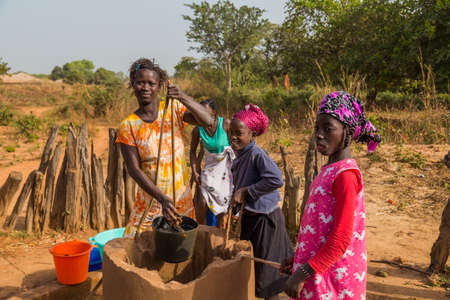 Bissau, Republic of Guinea-Bissau: women and children at the well for water, in the city of Bissau, Guinea Bissauのeditorial素材