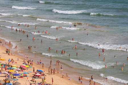 ALBUFEIRA, PORTUGAL: People at the famous beach of Olhos de Agua in Albufeira. This beach is a part of famous tourist region of Algarve.のeditorial素材