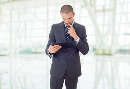 young businessman working with a tablet pc, at the officeの写真素材