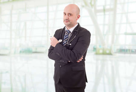happy male doctor with a syringe, at the hospitalの写真素材