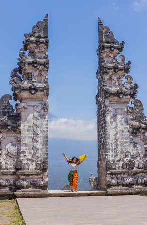 BALI, INDONESIA: Happy woman at the entrance temple of Pura Penataran Agung Lempuyang. In Bali, Indonesiaのeditorial素材