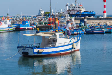 View of the small fishing port of Setubal with its typical blue boats on a summer day. Setubal, Portugalのeditorial素材