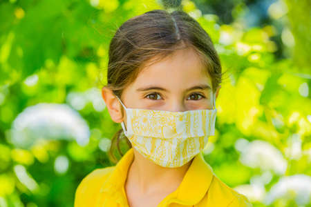 Little girl with mask against  outdoorの写真素材