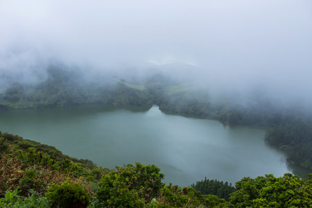 Deep lake in Flores Island, Azores Archipelago, Portugal. Green lagoon with green vegetationの写真素材