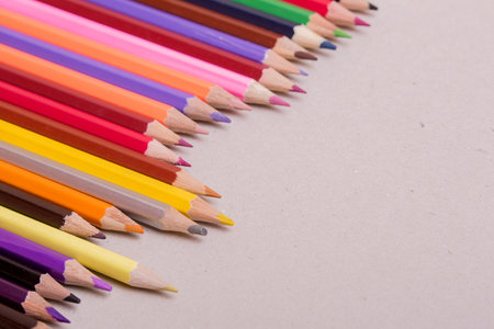 Wooden colorful pencils, on a grey paperの写真素材