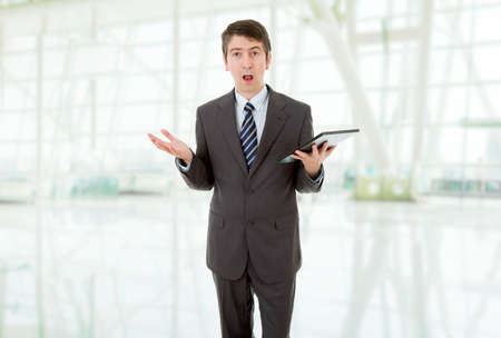 businessman surprised and waiting with a tablet pc, at the officeの写真素材
