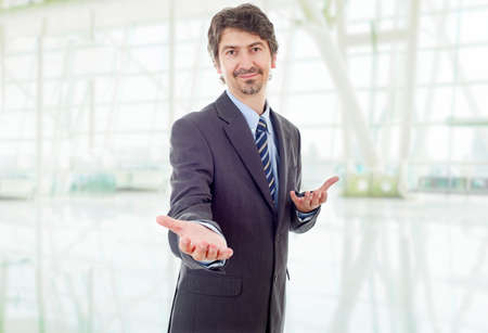 businessman in suit offering to shake the hand at the officeの写真素材