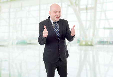 happy business man going thumb up, at the officeの写真素材