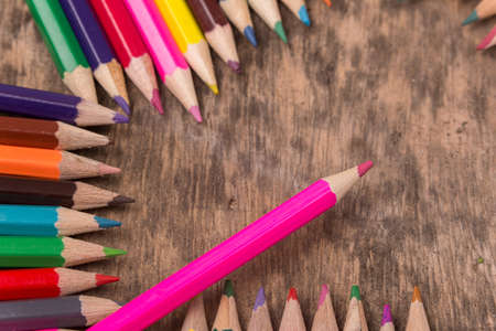 Wooden colorful pencils on a old wooden backgroundの写真素材