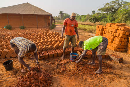 Workers making bricks of the land, outside bissau, Guinea Bissau