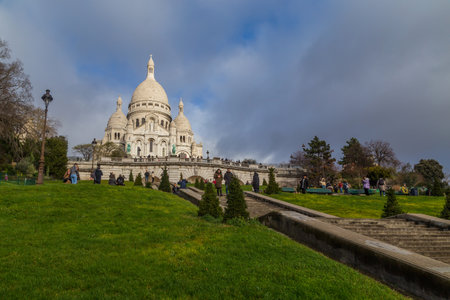 PARIS, FRANCE: Sacre-Coeur church, Paris citiscape view over the roofs with dramatic winter sky. Franceのeditorial素材