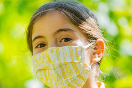 Little girl with mask againstの写真素材