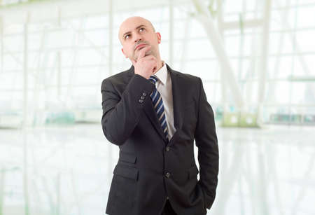 young business man thinking, at the officeの写真素材