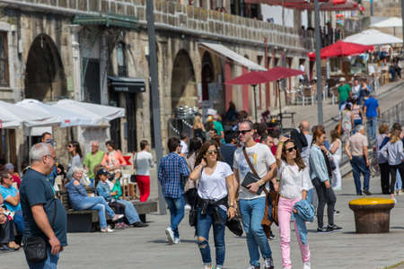 PORTO, PORTUGAL: Tourists and locals enjoy the Ribeira in the Douro River bank near the Dom Luis I Bridge, Porto, Portugal.のeditorial素材