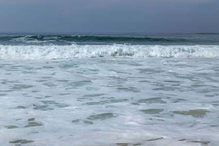waves at a empty beach near Aveiro, Portugalの写真素材