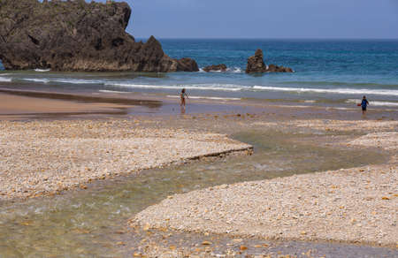 Llanes, Picos de Europa, Spain: People at the beach of San Antolin, Llanes, Asturias, Spainのeditorial素材