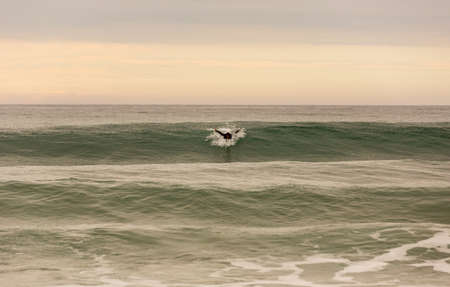 LA VEGA, ASTURIAS, SPAIN: Surfers on the beach of La Vega, at dusk, near Llanes, Asturias, Spainのeditorial素材