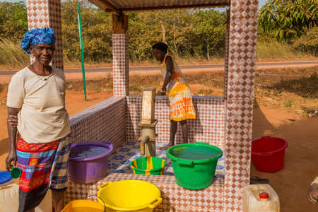 Bissau, Republic of Guinea-Bissau: women and children at the well for water, in the city of Bissau, Guinea Bissauのeditorial素材