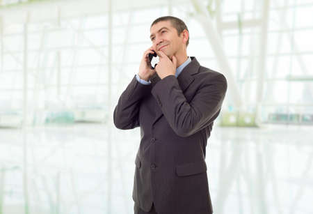 happy business man on the phone, at the officeの写真素材