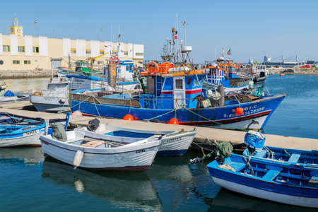 View of the small fishing port of Setubal with its typical blue boats on a summer day. Setubal, Portugalのeditorial素材