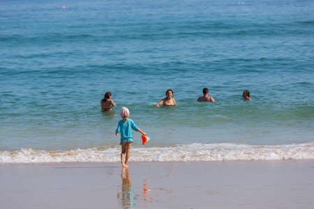 VILA DO BISPO, PORTUGAL: People at the famous beach of Salema in Vila do Bispo. This beach is a part of famous tourist region of Algarve.のeditorial素材