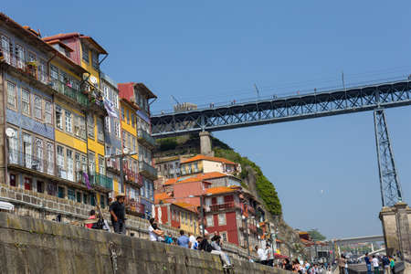 PORTO, PORTUGAL: Tourists and locals enjoy the Ribeira in the Douro River bank near the Dom Luis I Bridge, Porto, Portugal.のeditorial素材