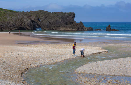 Llanes, Picos de Europa, Spain: People at the beach of San Antolin, Llanes, Asturias, Spainのeditorial素材