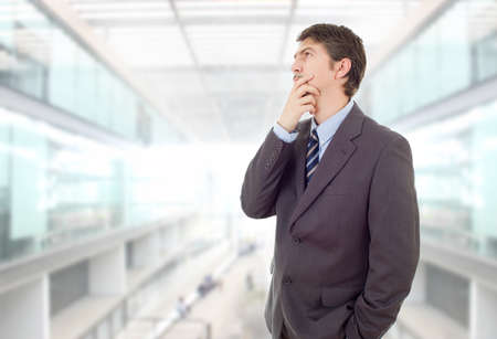 young business man thinking, at the officeの写真素材