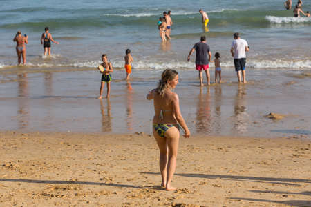 ALBUFEIRA, PORTUGAL: People at the famous beach of Olhos de Agua in Albufeira. This beach is a part of famous tourist region of Algarve.のeditorial素材