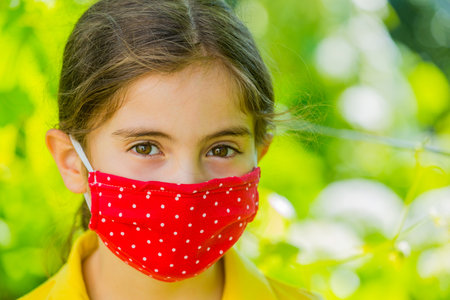 Little girl with mask outdoorの写真素材