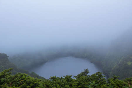 Deep lake in Flores Island, Azores Archipelago, Portugal. Green lagoon with green vegetationの写真素材