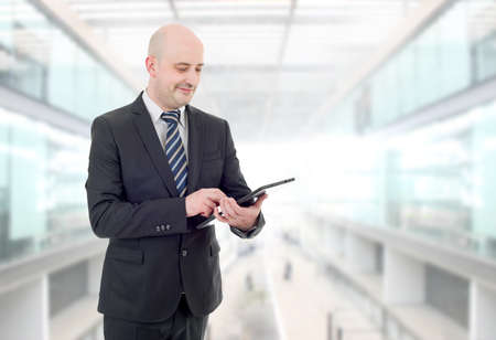 happy businessman with a tablet pc, at the officeの写真素材