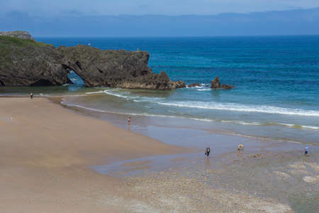Llanes, Picos de Europa, Spain: People at the beach of San Antolin, Llanes, Asturias, Spainのeditorial素材
