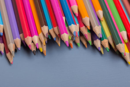 Wooden colorful pencils, on a blue wooden backgroundの写真素材
