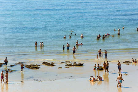 ALBUFEIRA, PORTUGAL: People at the famous beach of Olhos de Agua in Albufeira. This beach is a part of famous tourist region of Algarve.のeditorial素材
