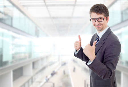 young business man going thumbs up, at the officeの写真素材