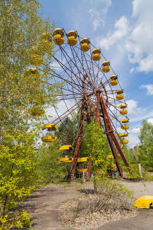 Old broken rusty metal radioactive electric wheel abandoned, the park of culture and recreation in the city of Pripyat, the Chernobyl disaster, Ukraine.の写真素材