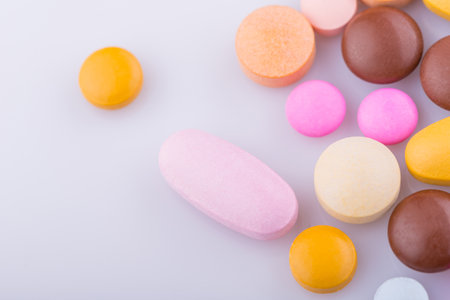 Tablets pills capsule heap mix therapy drugs, over a white backgroundの写真素材