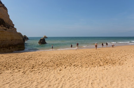 PRAIA DA ROCHA, PORTUGAL: People at the famous beach of Praia da Rocha in Portimao. This beach is a part of famous tourist region of Algarve.のeditorial素材