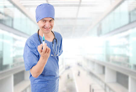 mad doctor with a syringe at the hospitalの写真素材