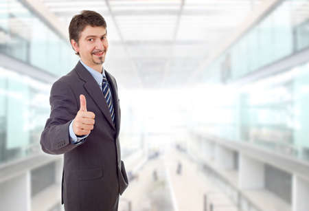young business man going thumb up, at the officeの写真素材