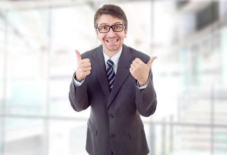 happy business man going thumb up, at the officeの写真素材