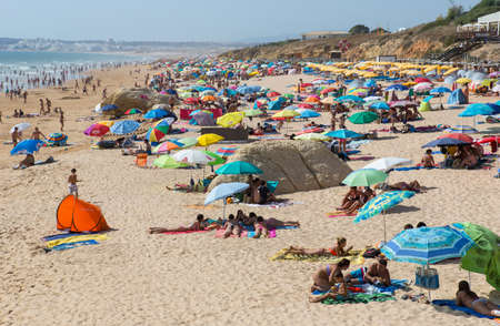 ALBUFEIRA, PORTUGAL: People at the famous beach of Olhos de Agua in Albufeira. This beach is a part of famous tourist region of Algarve.のeditorial素材