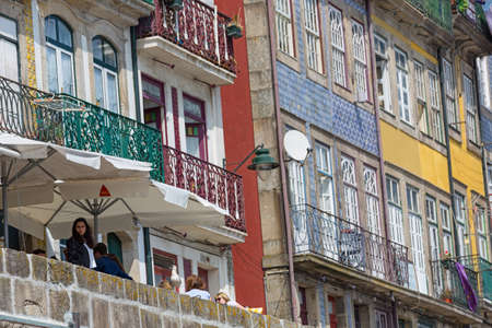 PORTO, PORTUGAL: Tourists and locals enjoy the Ribeira in the Douro River bank near the Dom Luis I Bridge, Porto, Portugal.のeditorial素材