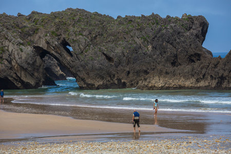 Llanes, Picos de Europa, Spain: People at the beach of San Antolin, Llanes, Asturias, Spainのeditorial素材