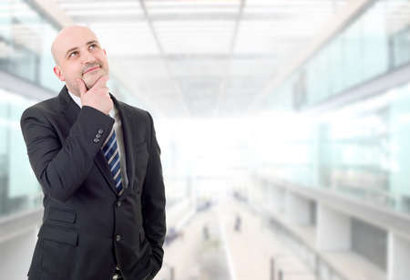 happy business man thinking, at the officeの写真素材
