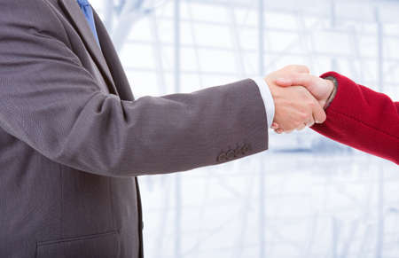 business couple shaking hands at the officeの写真素材
