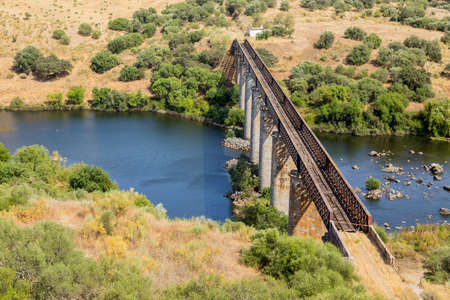 Old train bridge over the Guadiana river in the south of Portugal and Spain.の写真素材