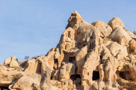 View of house carved in cave. Ruins of an ancient cave house. Historical rock dwellings. Cappadocia, Turkey.の写真素材