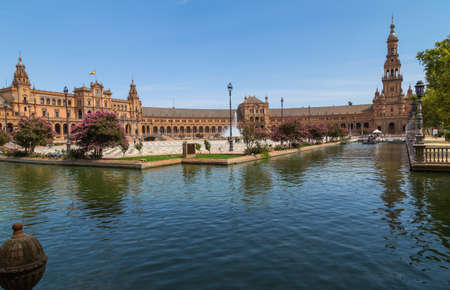 Seville, Andalusia, Spain: Central Renaissance building in Plaza de Espana square, view of Guadalquivir river with boats and people in the day time.のeditorial素材